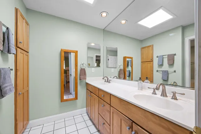 a bathroom with a double vanity sink and a mirror