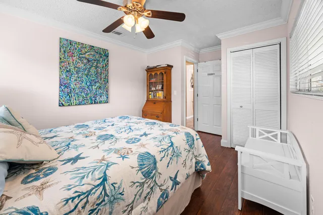 a bathroom with a granite countertop sink a toilet a mirror and shower