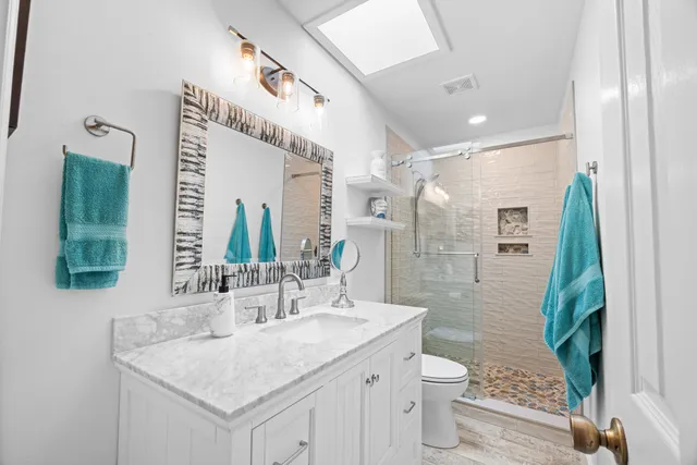 a bathroom with a double vanity sink and a mirror