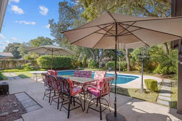 swimming pool view with a seating space and a garden