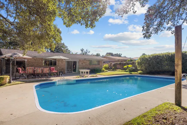a backyard of a house with outdoor seating and green space