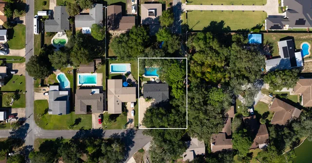 an aerial view of multiple houses with yard