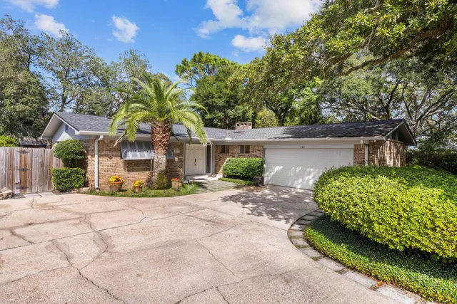 a view of a hallway with a dining table and chairs
