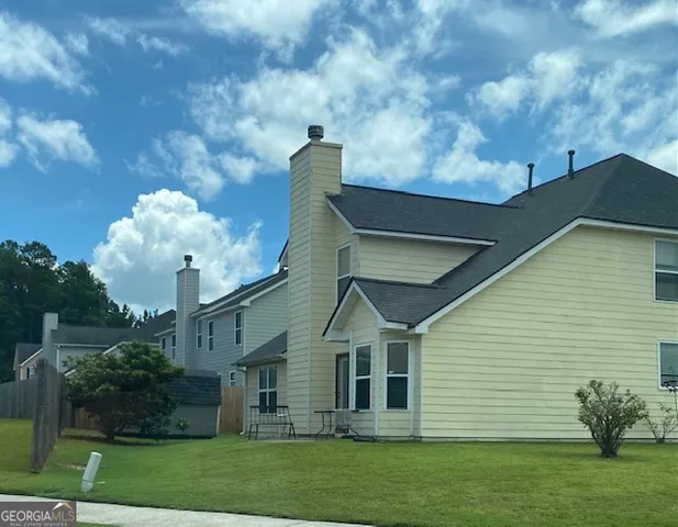 a swimming pool with outdoor seating and yard