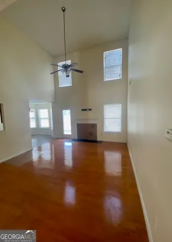a view of a room with wooden floor staircase and windows