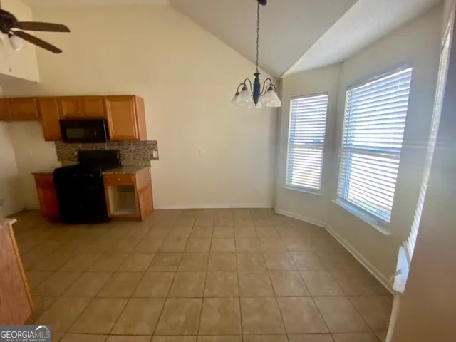 a view of a livingroom with furniture wooden floor and windows