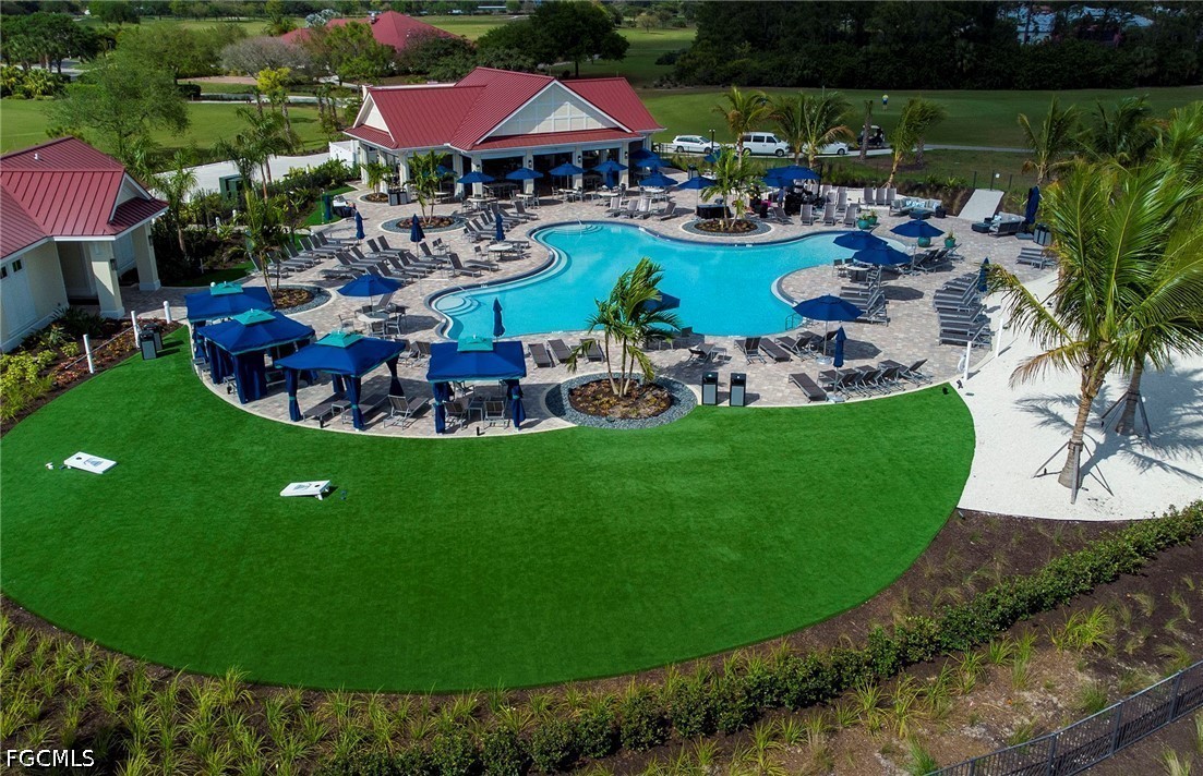 16969 Oakstead Drive Alva, FL 33920 - Photo 18 of 20 a view of a swimming pool and lounge chair
