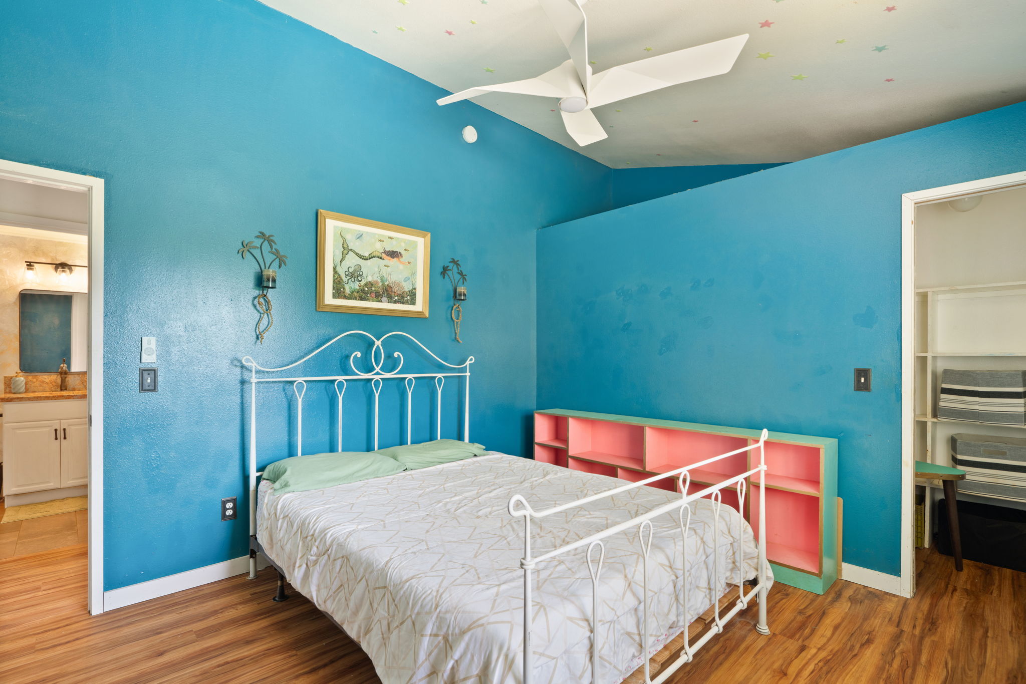 6100 Kawaihau Road Kapaa, HI 96746 - Photo 12 of 22 a bedroom with a bed and a wooden floor
