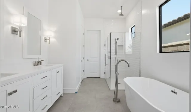 a bathroom with double vanity sinks and a mirror