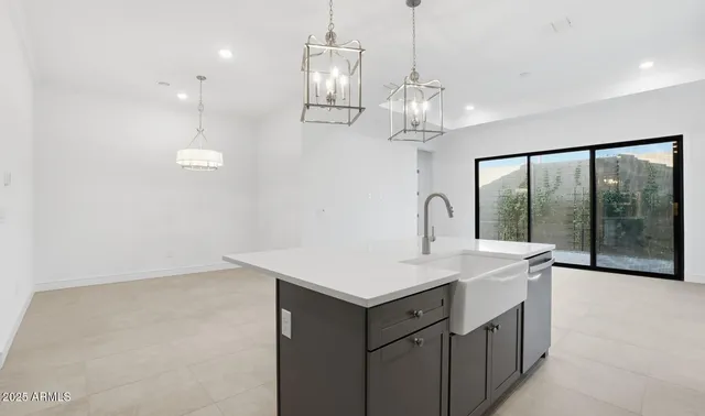 a large kitchen with stainless steel appliances kitchen island granite countertop a refrigerator and a view of living room