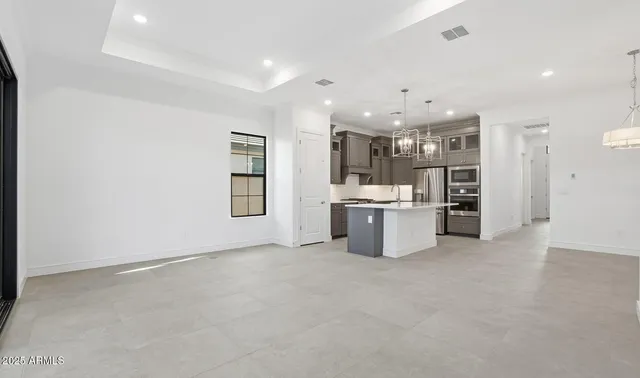 a room with a sink and chandelier
