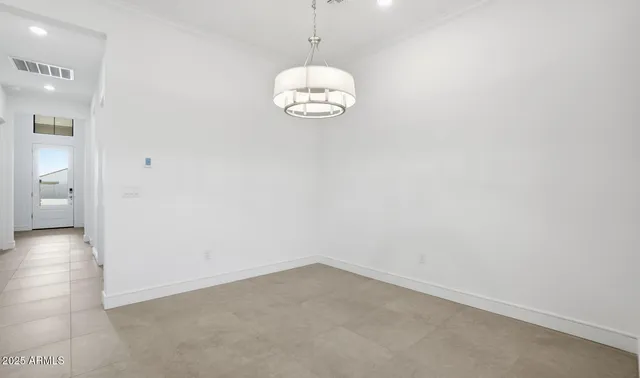 an empty room with stainless steel appliances kitchen island granite countertop a refrigerator and a stove top oven