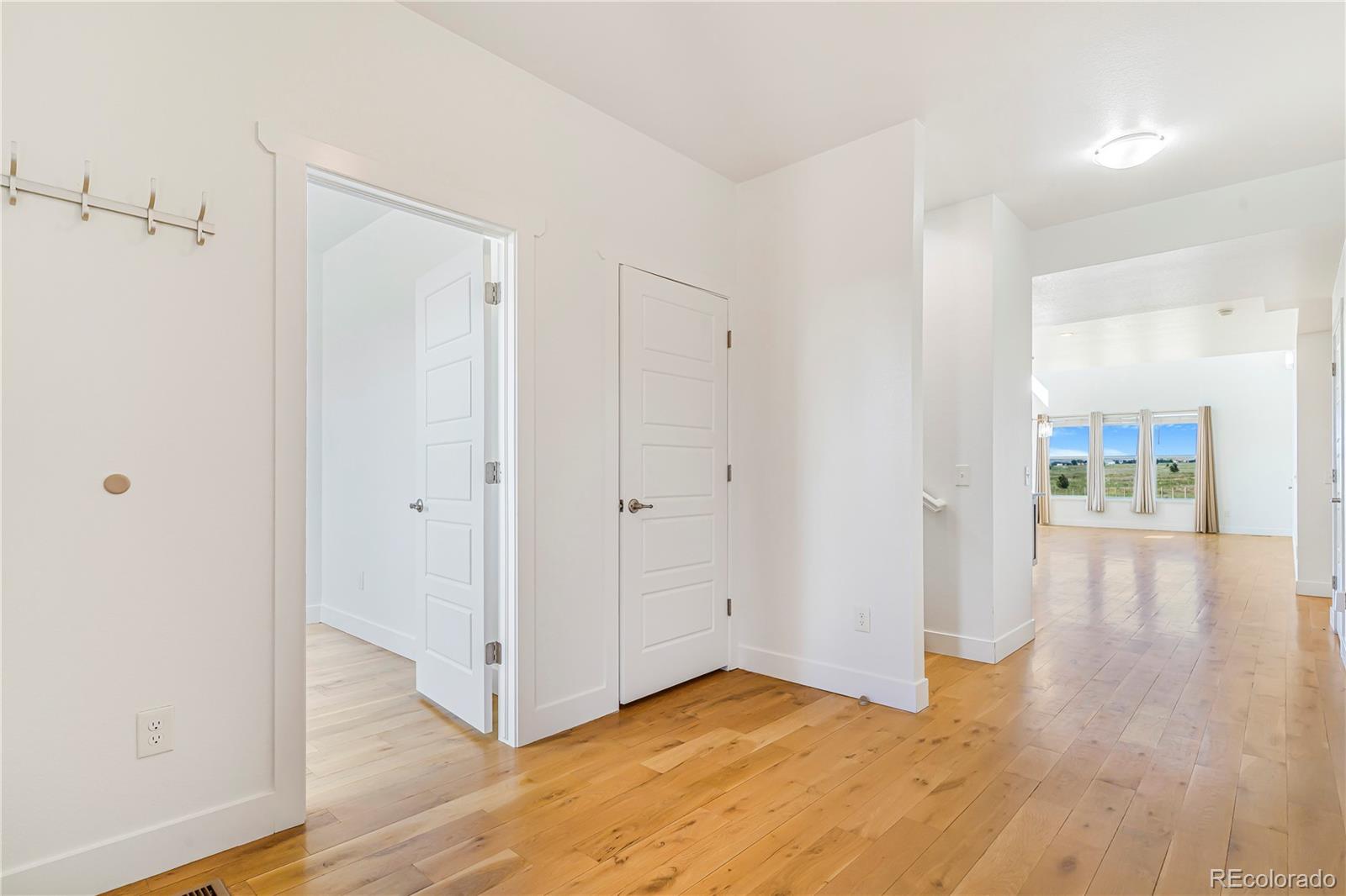 497 Valley Way Bennett, CO 80102 - Photo 11 of 37 a view of an empty room and wooden floor