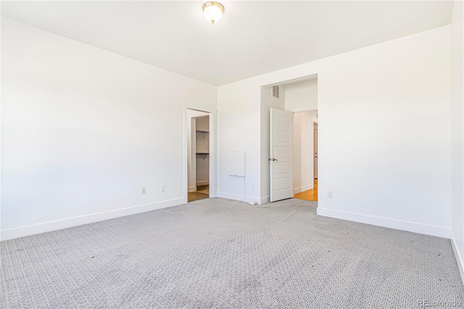 497 Valley Way Bennett, CO 80102 - Photo 14 of 37 an empty room with an entryway