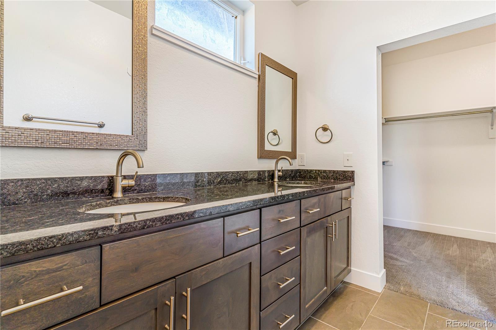 497 Valley Way Bennett, CO 80102 - Photo 17 of 37 a bathroom with a sink and a mirror