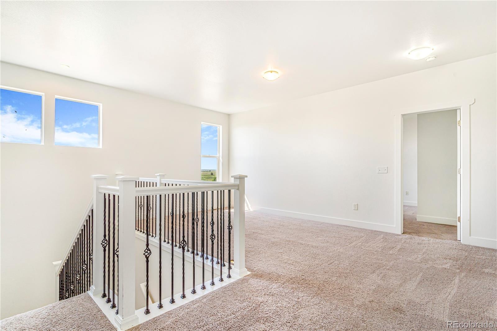 497 Valley Way Bennett, CO 80102 - Photo 18 of 37 a view of hallway with wooden floor