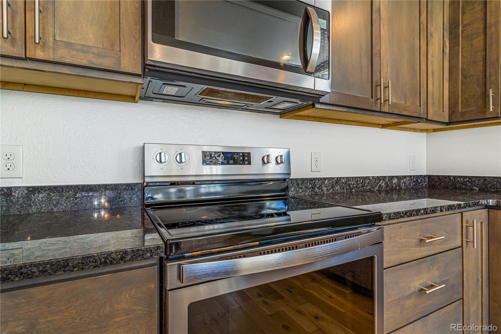 497 Valley Way Bennett, CO 80102 - Photo 4 of 37 a stove top oven sitting inside of a kitchen