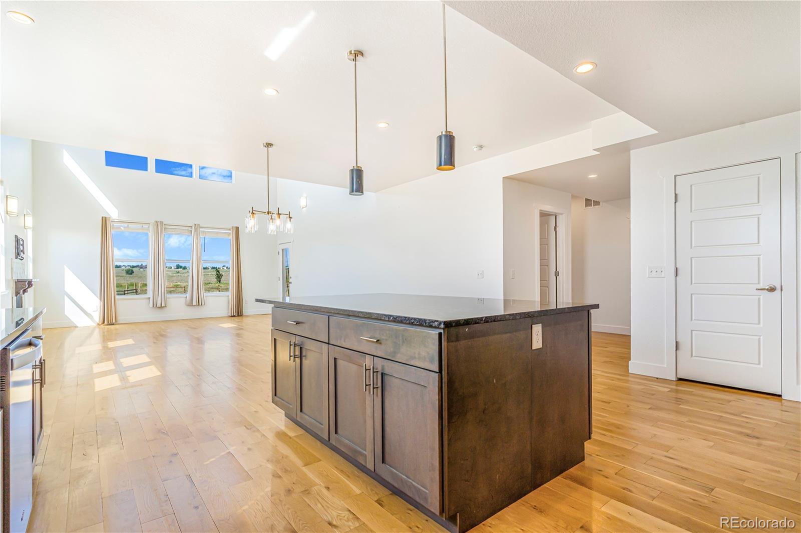 497 Valley Way Bennett, CO 80102 - Photo 7 of 37 a kitchen with stainless steel appliances granite countertop a refrigerator a sink and a stove