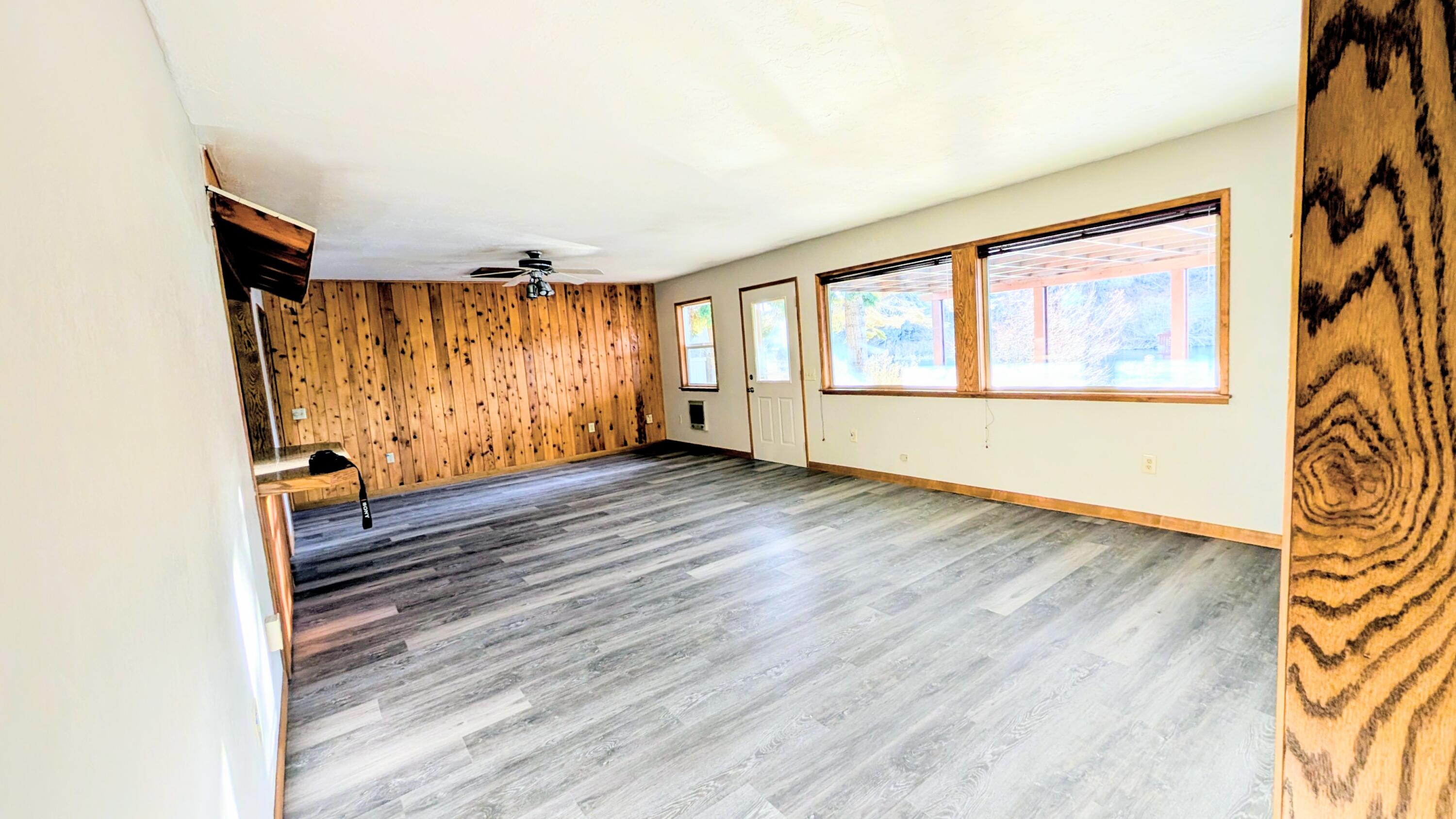 32550 Rivers Drive Chiloquin, OR 97624 - Photo 4 of 24 an empty room with wooden floor and windows