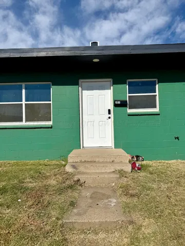 a backyard of a house with table and chairs