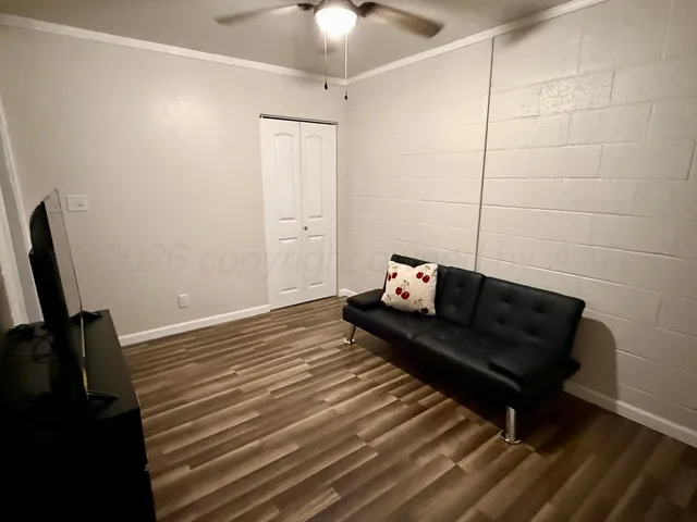 a view of a room with furniture and wooden floor