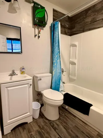 a white toilet sitting next to a bathroom sink and vanity