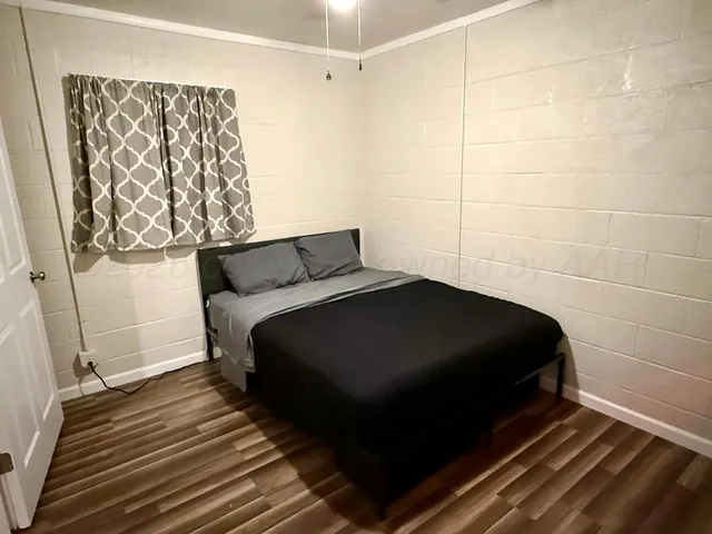 a bedroom with a bed and a window