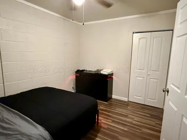 a bedroom with a bed and a mirror