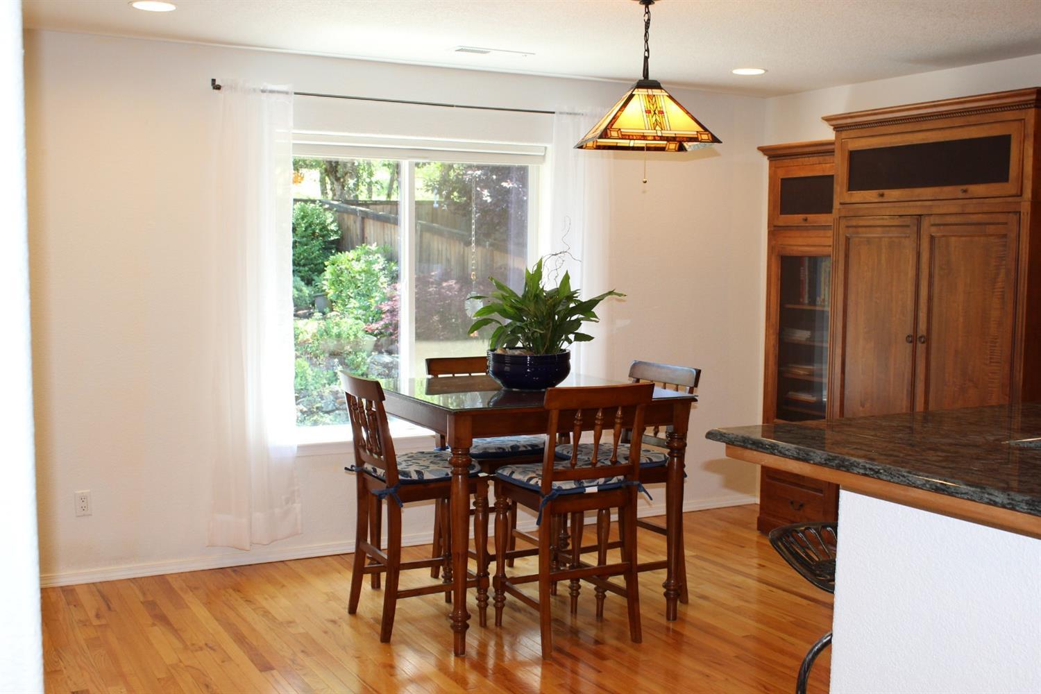 1246 Poppy Ridge Drive Eagle Point, OR 97524 - Photo 11 of 34 a dining room with furniture window wooden floor