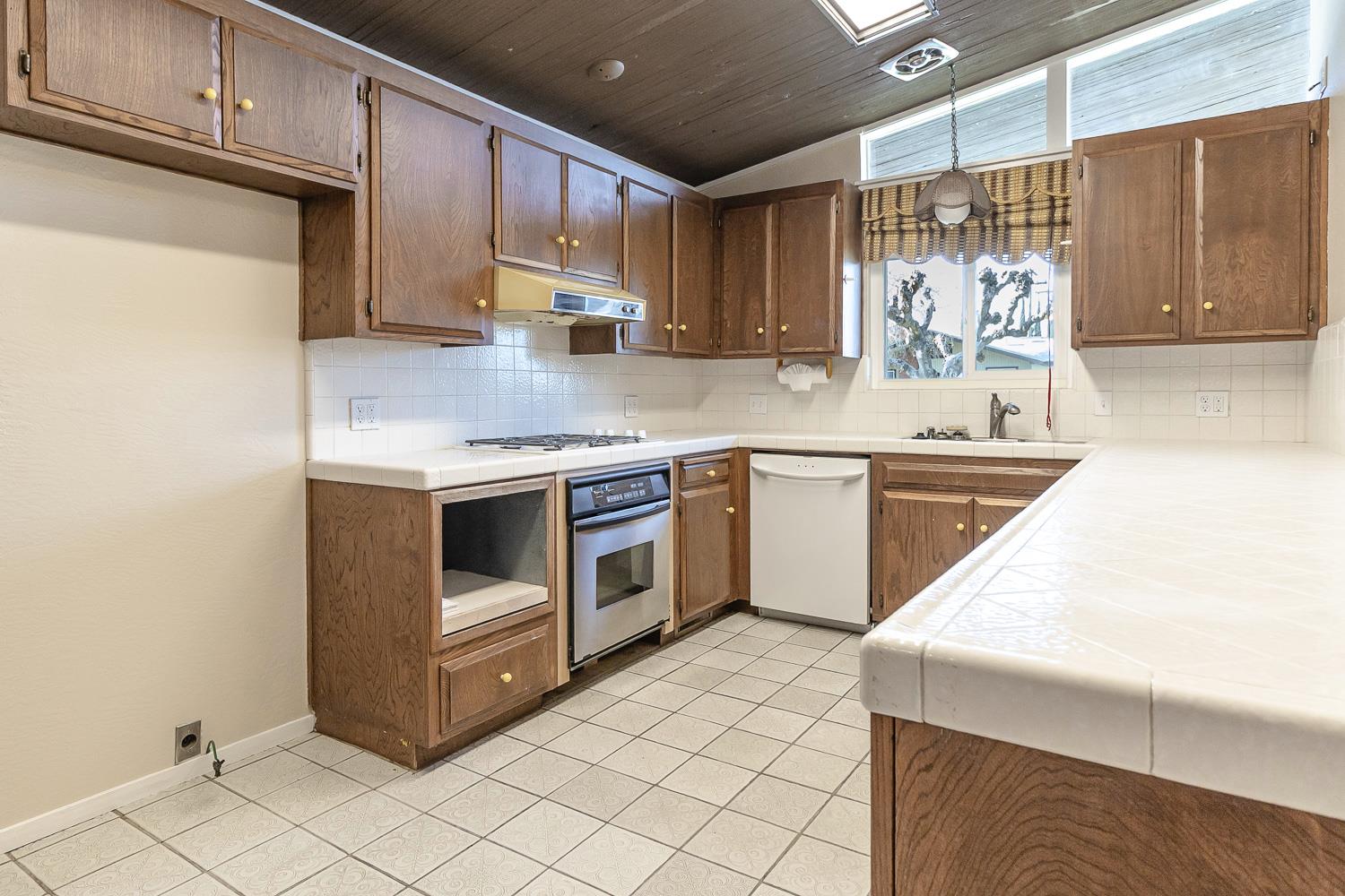 1506 Madison Avenue Tracy, CA 95376 - Photo 7 of 21 a kitchen with a stove sink and cabinets