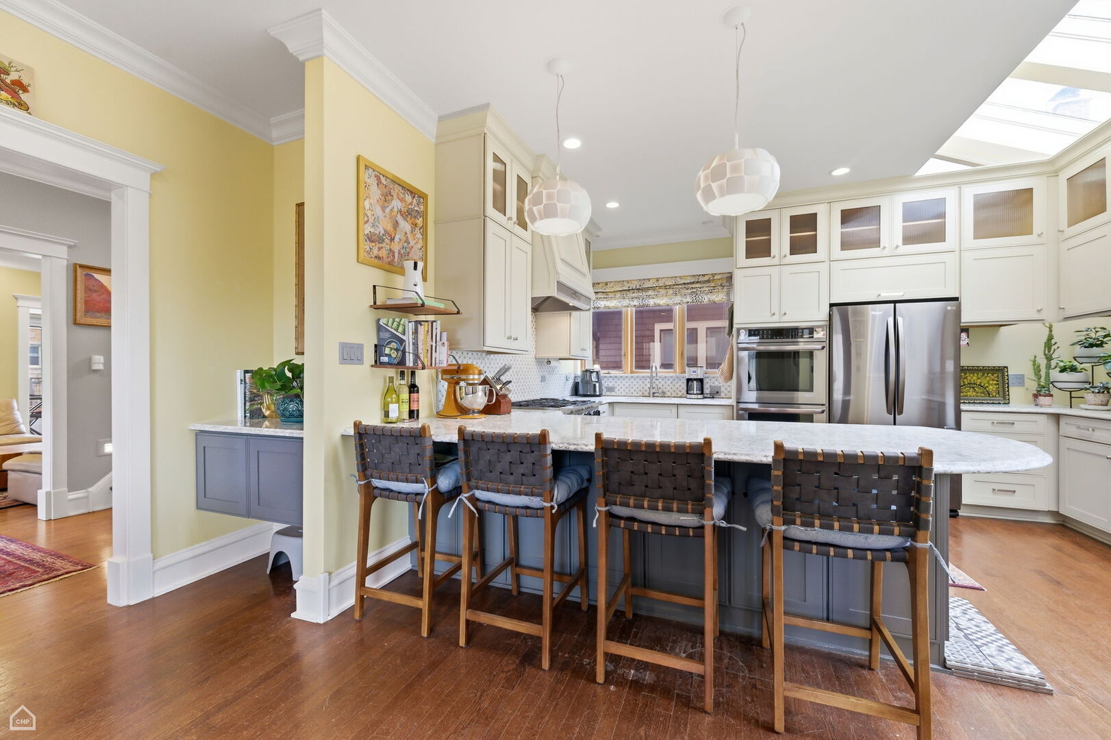 1516 West Sherwin Avenue Chicago, IL 60626 - Photo 10 of 45 a dining hall with stainless steel appliances kitchen island granite countertop wooden floor a dining table and chairs