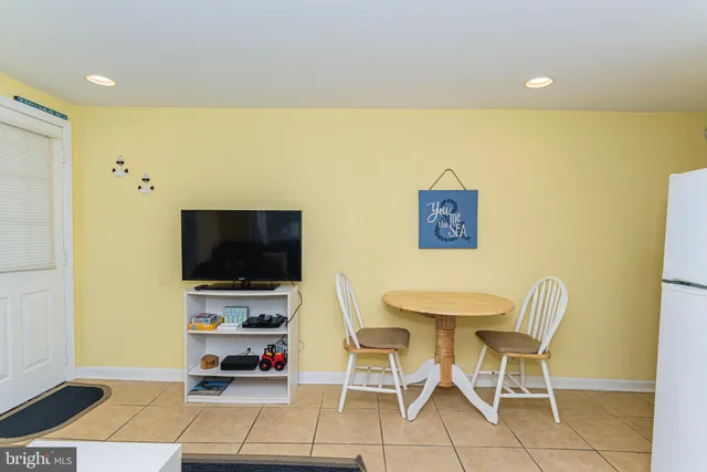 a living room with a flat screen tv and furniture