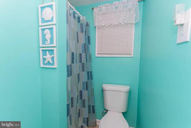 a white toilet sitting next to a bathroom sink