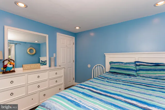 a bedroom with a bed and a dresser