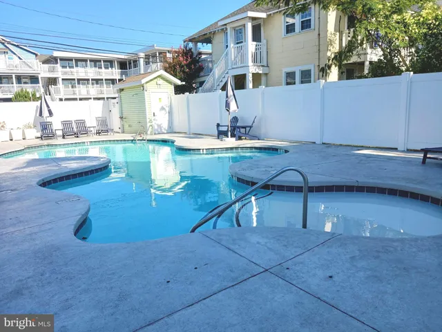 a view of a house with pool and a yard