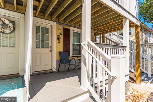 a view of front door of house with wooden stairs