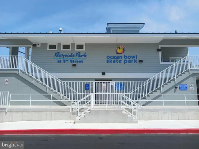 a view of swimming pool with outdoor seating and buildings in the background