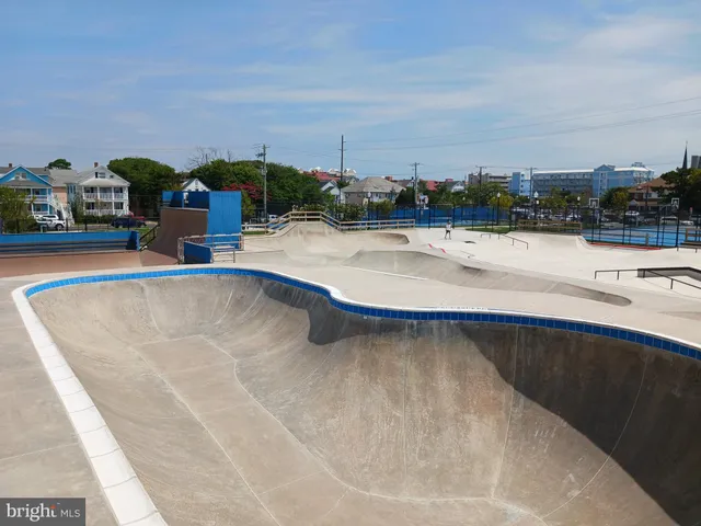 a bench is sitting in the grass with a view of lake