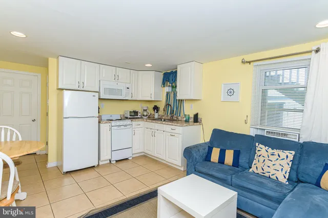 a kitchen with a refrigerator and a stove top oven