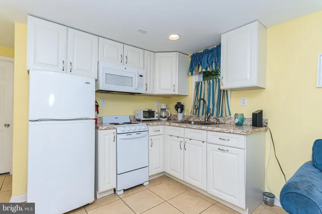 a kitchen with appliances a sink and cabinets