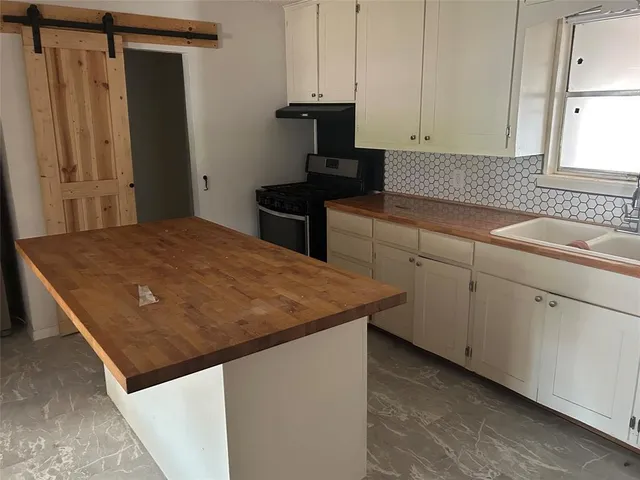 a kitchen with a sink and cabinets