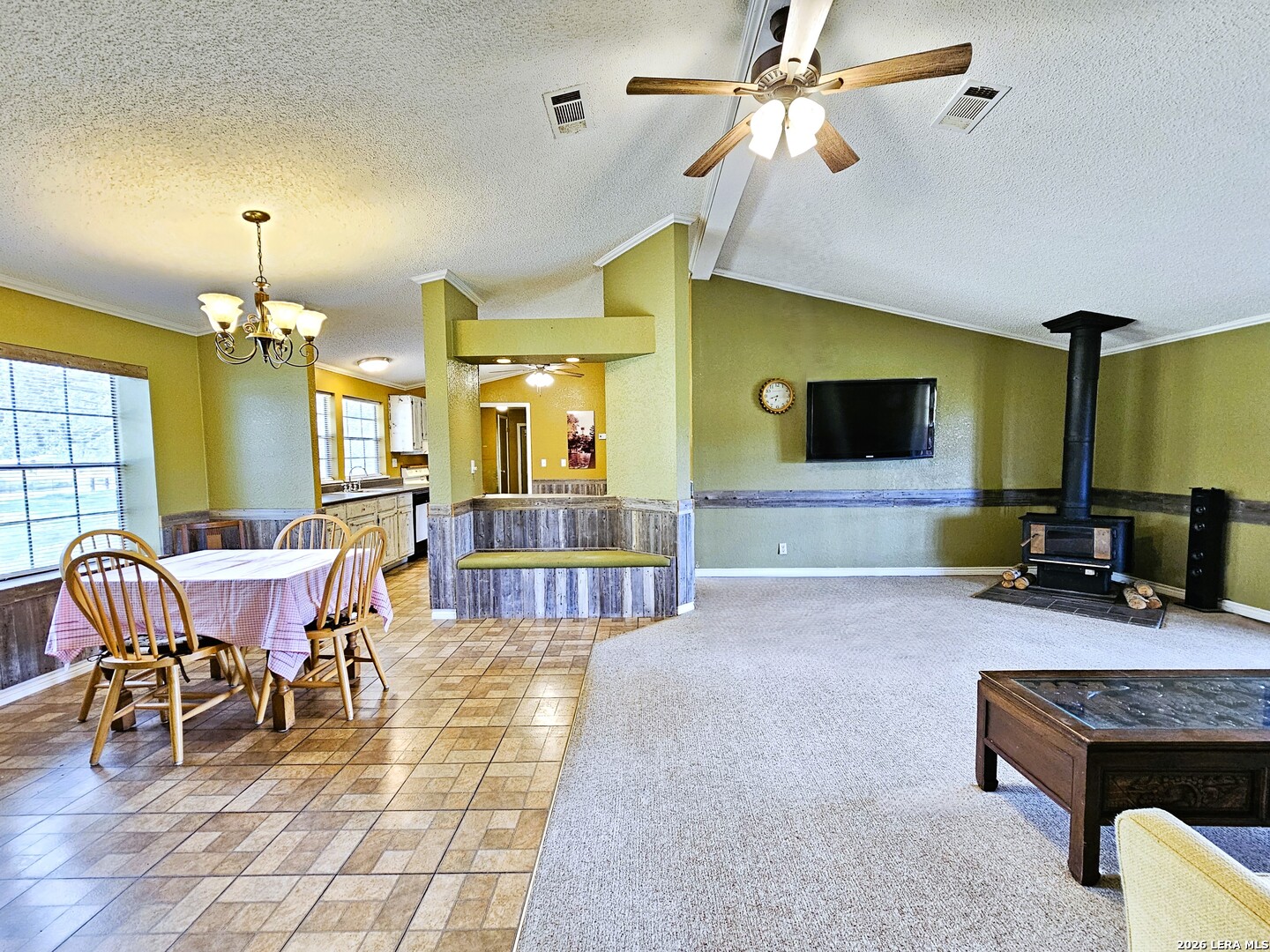 799 County Road 6612 Devine, TX 78016 - Photo 18 of 32 a living room with furniture a dining table and a fireplace