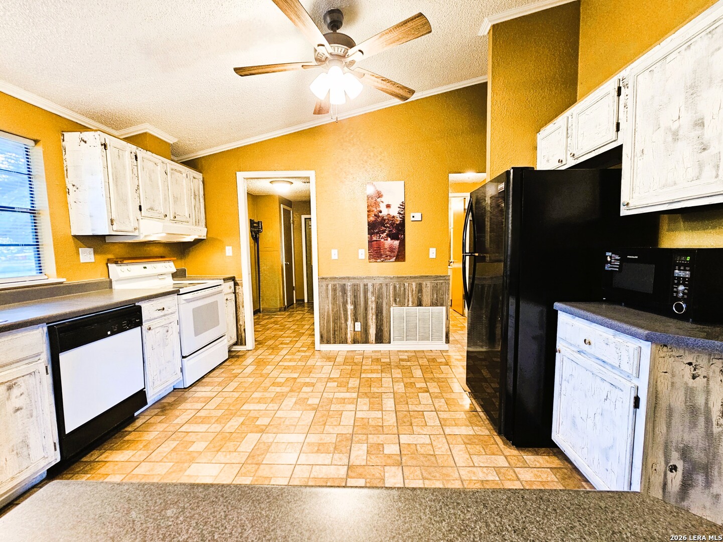 799 County Road 6612 Devine, TX 78016 - Photo 19 of 32 a kitchen with stainless steel appliances granite countertop a refrigerator a stove top oven and a sink