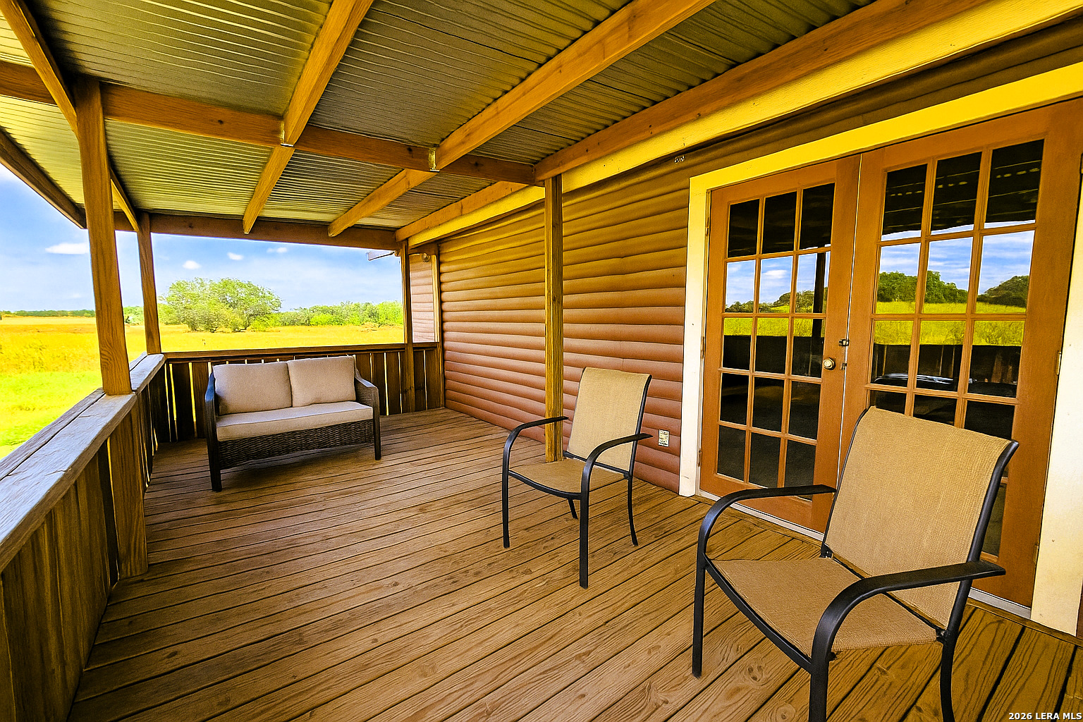 799 County Road 6612 Devine, TX 78016 - Photo 24 of 32 a view of a chairs and table in the balcony