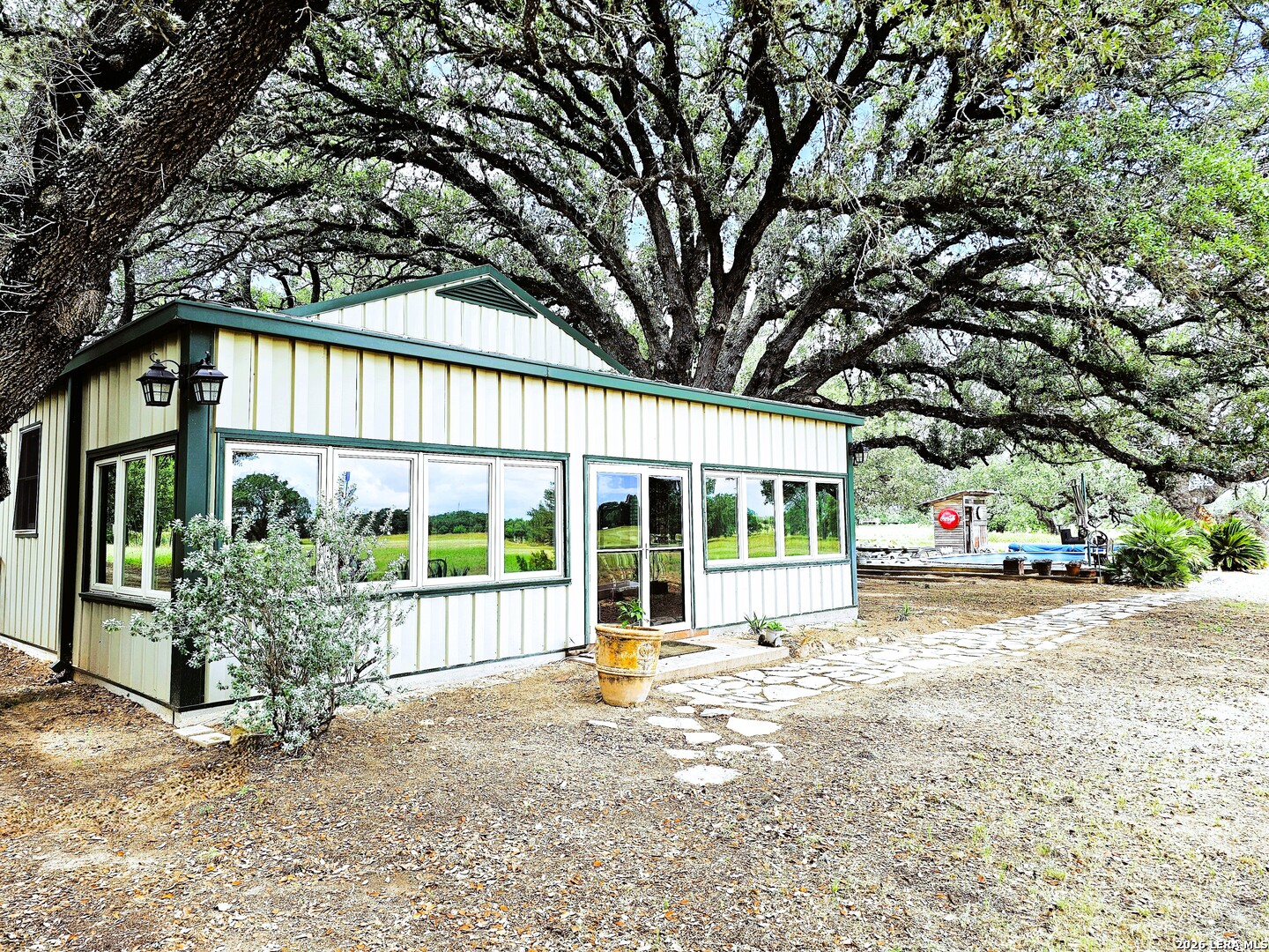 799 County Road 6612 Devine, TX 78016 - Photo 4 of 32 a front view of a house with a garden