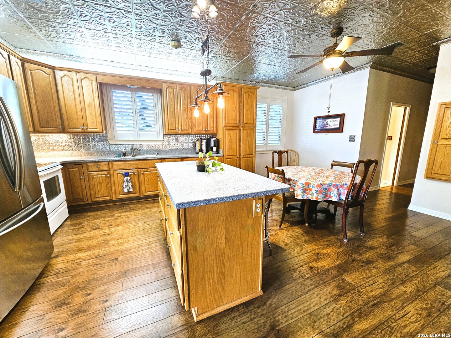 799 County Road 6612 Devine, TX 78016 - Photo 6 of 32 a dining hall with stainless steel appliances granite countertop a stove and a dining table view
