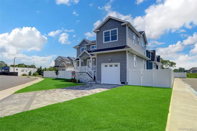 a view of a house with a yard and sitting area