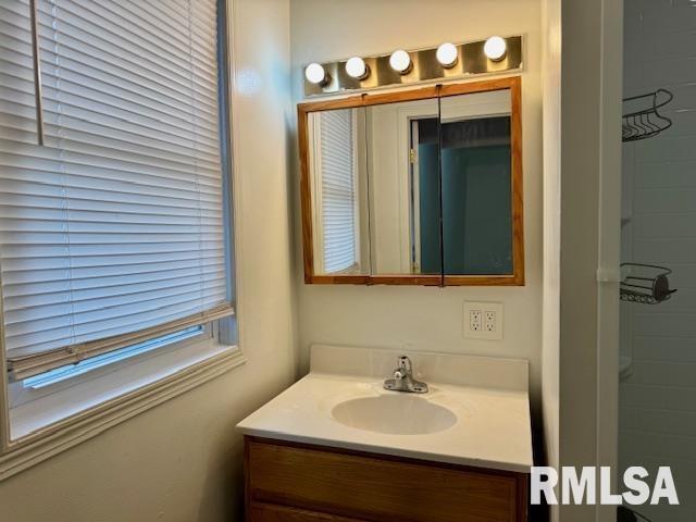 765 9th Avenue South Clinton, IA 52732 - Photo 13 of 25 a bathroom with a sink and a mirror