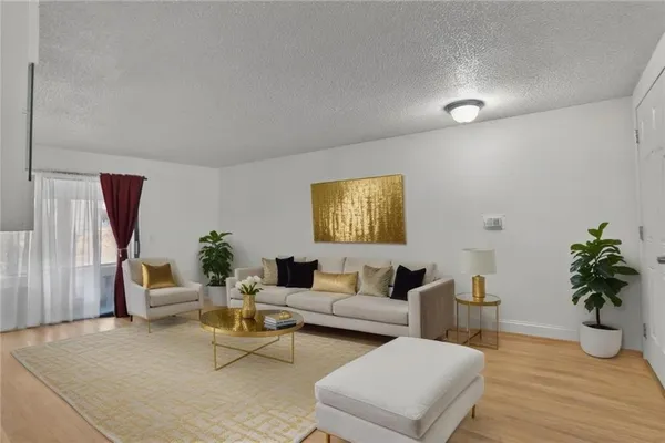 a living room with furniture and a potted plant