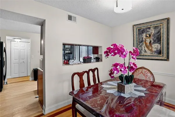 a view of a dining room with furniture and wooden floor